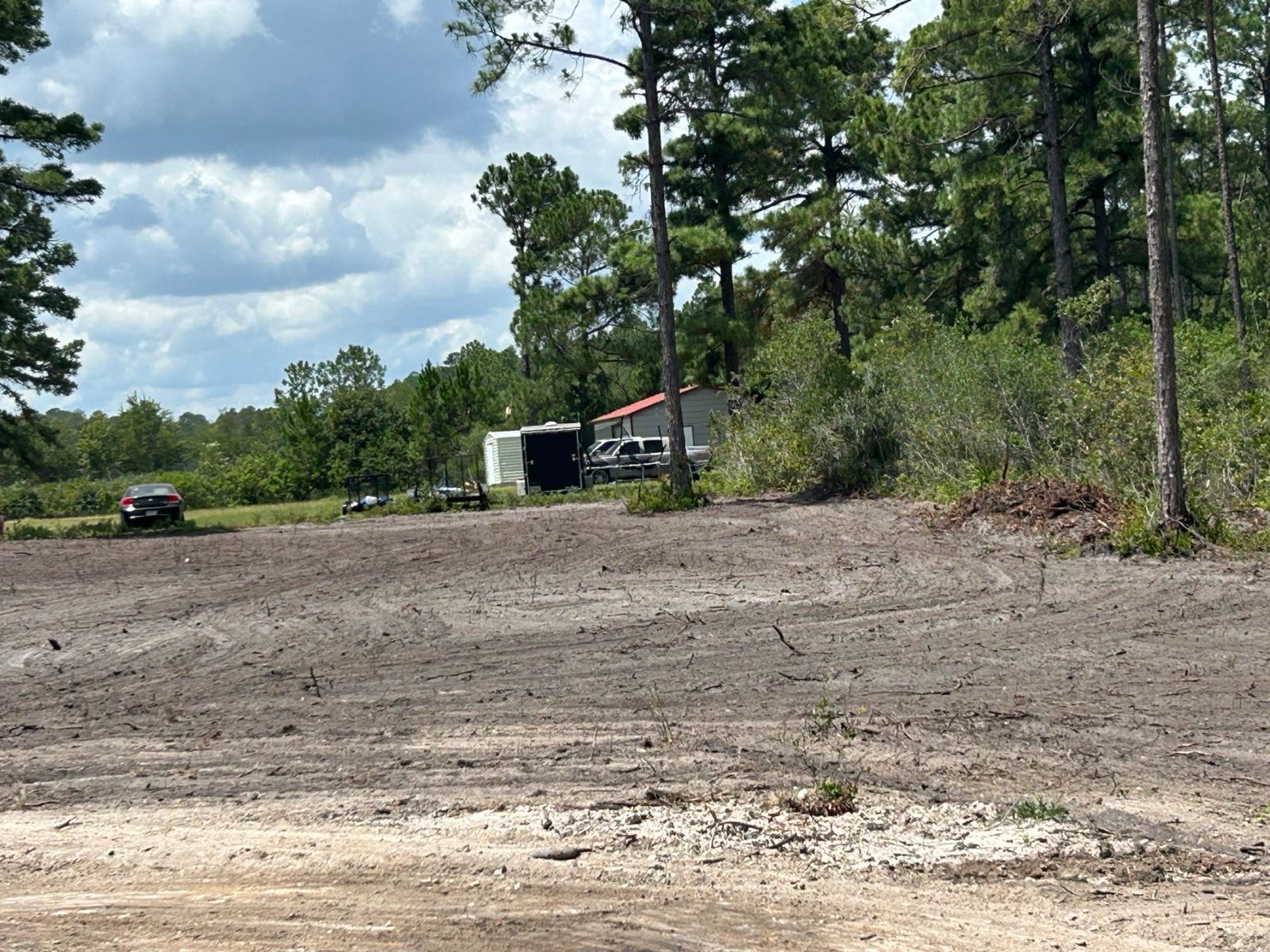 Cleared and graded lot at the wood line